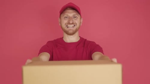 Bearded Man Holds Package and Smiles