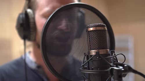 Cinematic shot of studio microphone and singer, extreme closeup