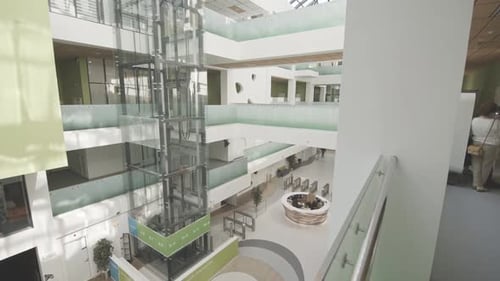 Elevator with Glass Shaft and Bridges in Office Center