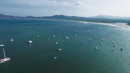 Aerial Top Down View of a Sailing Boat Anchored on a Emerald Reef