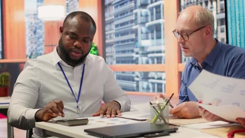 Financial Team Reviews Data in Modern Office