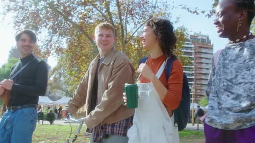Cheerful Friends Chatting and Walking through the Park after Study