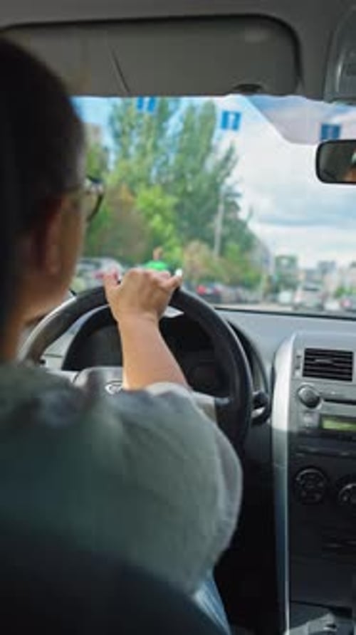 Businesswoman Navigating City Streets While Driving to Work
