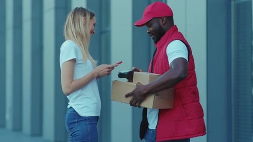 African American Delivery Man Hold Package Woman Client Paying By Phone for Parcel Transporting