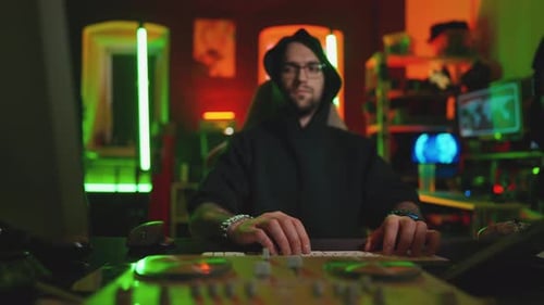 Hacker Writing Code Cracking Computer Man Programmer in Hoodie Cracks System Using Computer in Dark