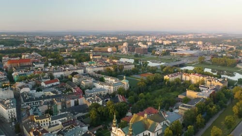 Drone Descends with Vistula River and Riverwalk in Background at Sunrise