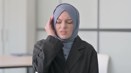 Woman in Headscarf Massaging Temples