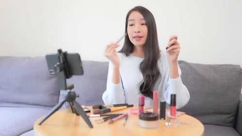 Woman Applies Makeup While Recording Video
