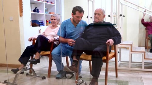 Elderly Couple Doing Physical Therapy with Physiotherapist in Nursing Home