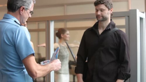 Airport Security Person Checks Passports and Tickets 25-30