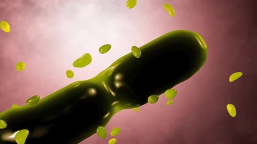 Vibrant green capsule dissolving with yellow particles around it