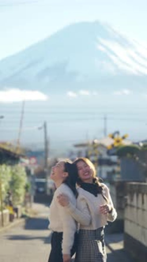 4K Asian woman friends travel small town near mt Fuji in Japan together in autumn.