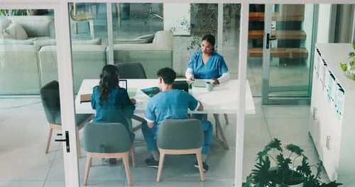 Doctors, meeting and documents in boardroom at clinic, above and review with paperwork