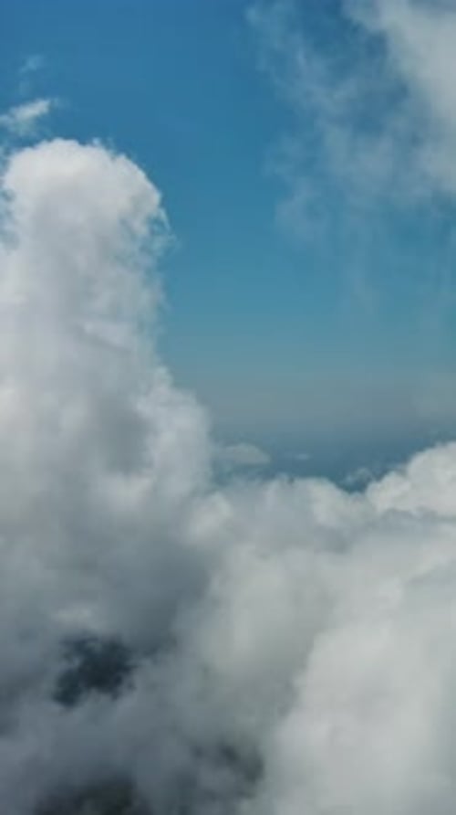 Flying through white clouds over sea