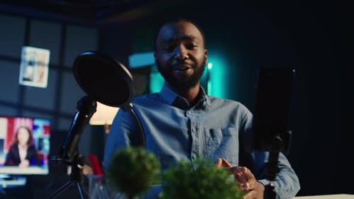 Man Recording Podcast with Microphone and Smart Phone