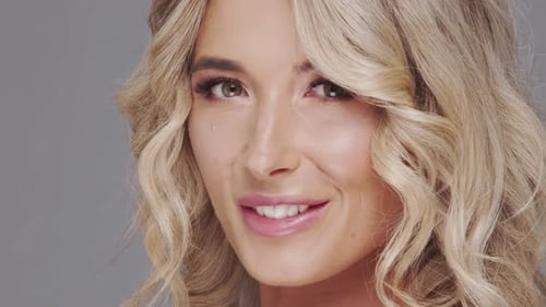 Studio Portrait of Young and Beautiful Blond Woman Over Grey Background Skin Care and Wellness