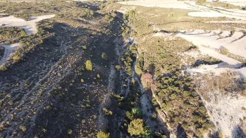 Dry vegetation rural terrain land, aerial drone video over landscape valley