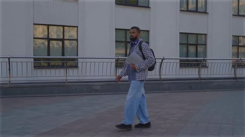 Handsome Black Male University Student with Exercise Books on the Way to College