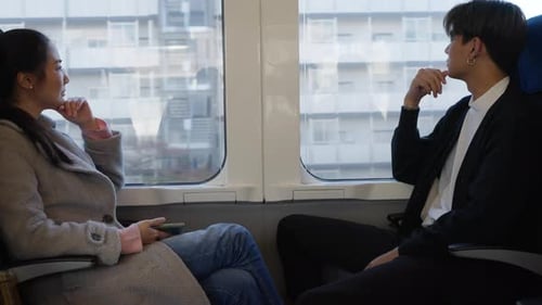 Woman and Man Traveling by Train Together