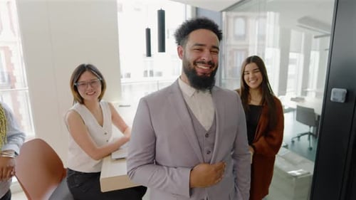 A Diverse Team Engaged in a Modern Office Setting Showcasing Ambition and Collaboration
