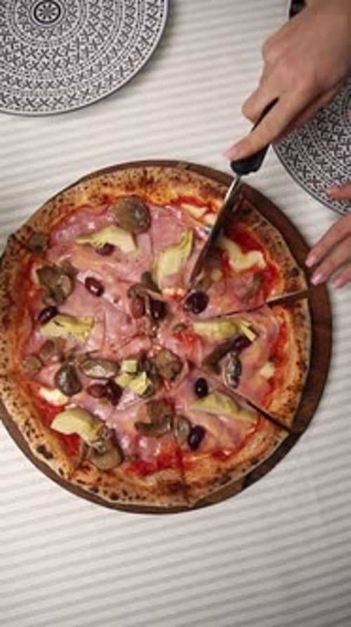 The chef makes delicious pizza in a professional kitchen.