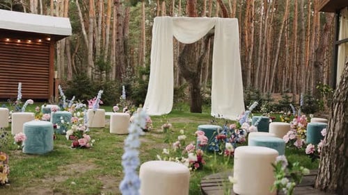 Wedding Ceremony Setup with Floral Decorations in Forest