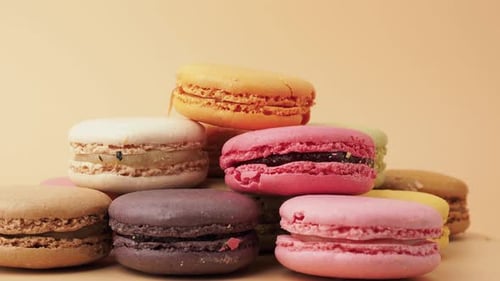Stack of Colorful Macarons on Peach Background