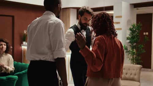 Couple Checking Into Hotel at Reception Desk