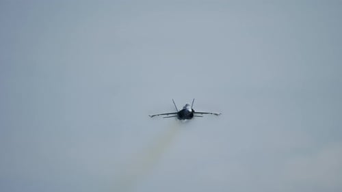 Slow Motion Fighter Jet Leaving Vapor Trail Approaching Camera