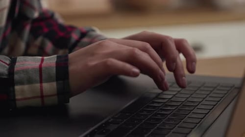 Hands Typing on Laptop Keyboard Close Up