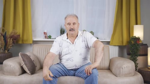 Old man nodding in a positive way.