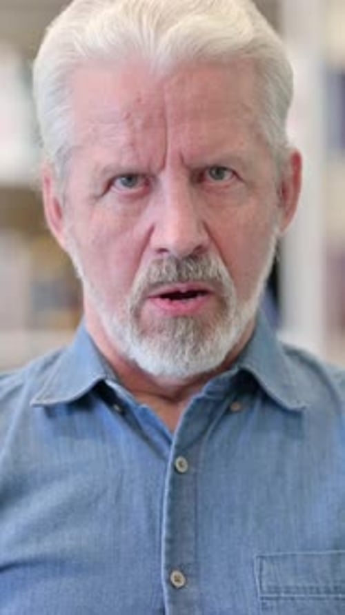 Man with Gray Hair and Beard Looking at Camera