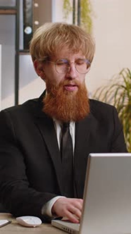 Young Business Man Freelancer at Office Start Working on Laptop Computer Sends Online Messages