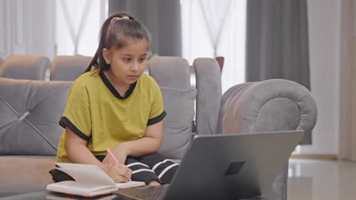 Indian kid girl studying from an online course