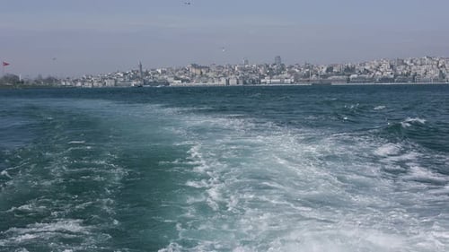 a Ferry Trail on the Water Against the Backdrop of Istanbul in Turkey