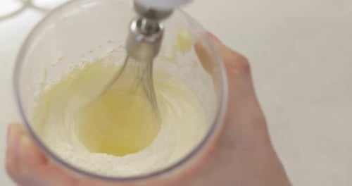 Female Hands Using Electric Mixer for Cooking