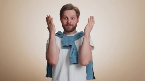 Man Expressing Joy and Surprise with Hand Gestures