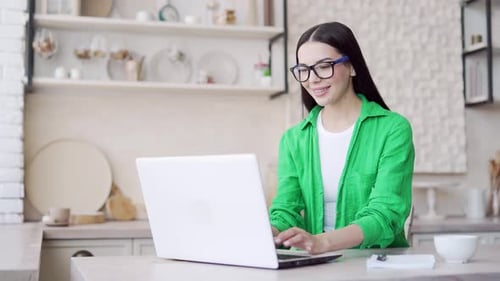 Excited Woman Working on Laptop at Home