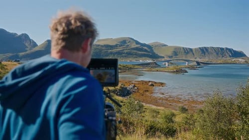 Back View Of A Filmmaker Recording A Bridge