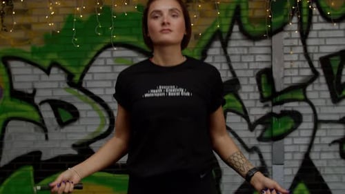 Woman trains and jumps rope, coordination training, crossfit training day in the gym, strength fit b