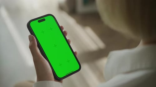 Person Holding Smartphone with Green Screen