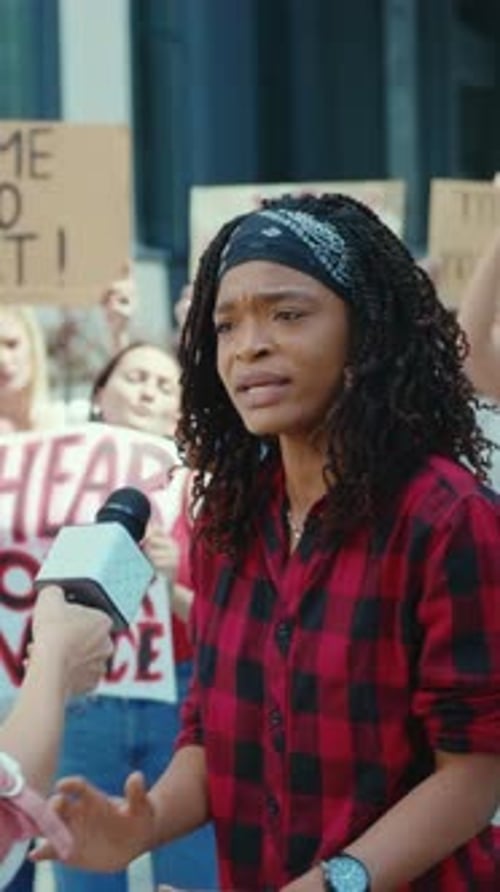 Young Adult Speaking at Lively City Protest