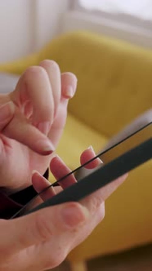 Close Up of Unrecognizable Woman Using Mobile Phone Touchscreen at Home