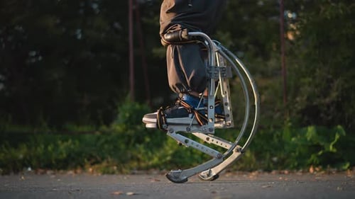 CloseUp Jumping on Metallic Spring Stilts Outdoors