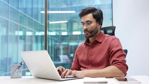 Confident corporate operator who works in customer support speaks on a video call using a laptop.