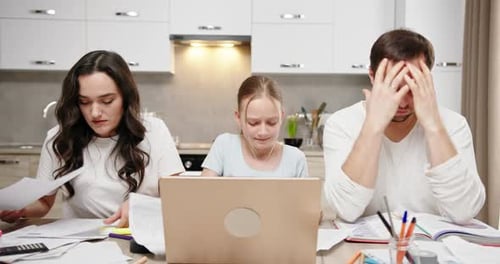 Family Mom and Dad Daughter Sitting at the Table at Home Studying Online Annoyed Tired Sad Throwing