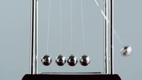 Newtons Cradle Demonstrates Momentum and Kinetic Energy