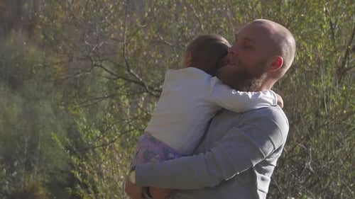 Loving Father Holding Daughter in Natural Light