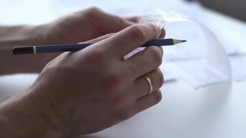 Guy checks bills, taxes, bank account balance and expense calculation using smartphone.