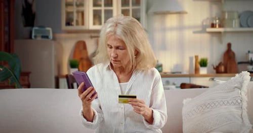 Old Woman Talking with Phone Scammers Reporting Data of Bank Card Fraud Portrait of Grandmother at
